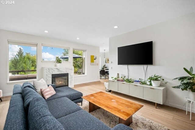 8427 NW Timber Ridge Ct, Portland, OR 97229 - living room with light wood-style floors, baseboards, and recessed lighting
