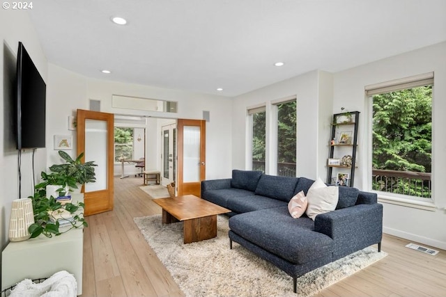 8427 NW Timber Ridge Ct, Portland, OR 97229 - living room with light wood-type flooring, recessed lighting, baseboards, and french doors