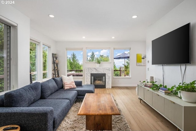 8427 NW Timber Ridge Ct, Portland, OR 97229 - living room with light wood-type flooring, recessed lighting, a high end fireplace, and baseboards