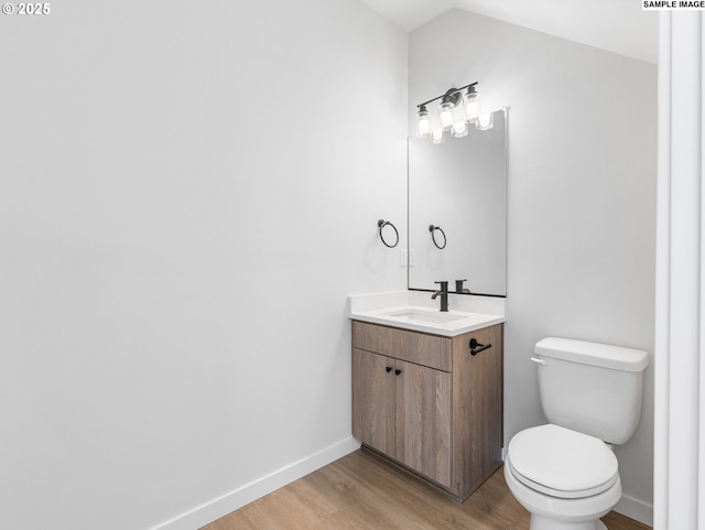 4043 SE 115th Ave, Portland, OR 97266 - half bath with wood finished floors, vanity, toilet, baseboards, and lofted ceiling