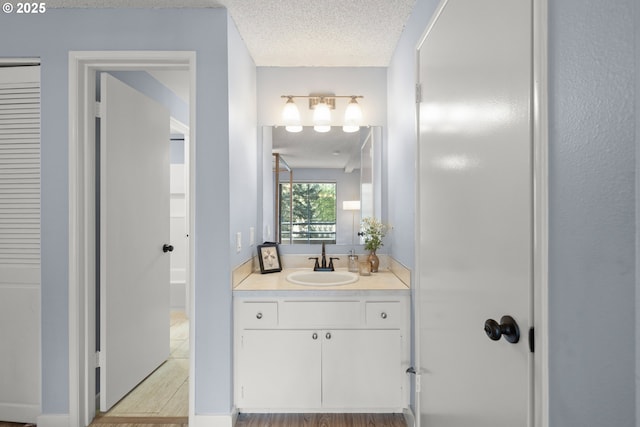 bathroom featuring a textured ceiling and vanity