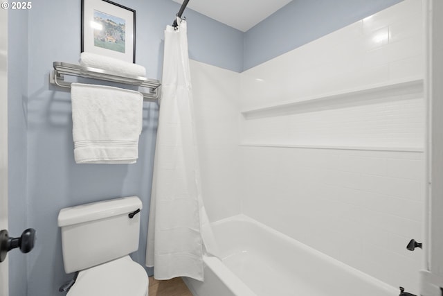 bathroom featuring shower / bath combination with curtain and toilet