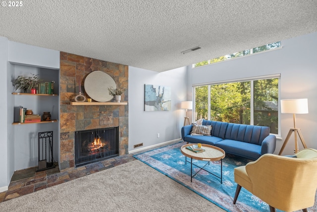 living room featuring a textured ceiling, visible vents, a stone fireplace, and baseboards