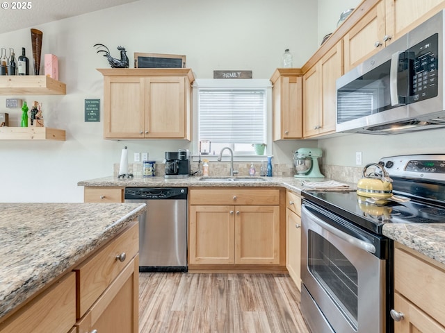 3190 Lily Ln, Mcminnville, OR 97128 - kitchen with stainless steel appliances, light brown cabinetry, a sink, light wood-style flooring, and light stone counters
