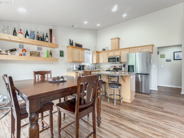 3190 Lily Ln, Mcminnville, OR 97128 - dining space with a towering ceiling, light wood-style flooring, baseboards, and recessed lighting