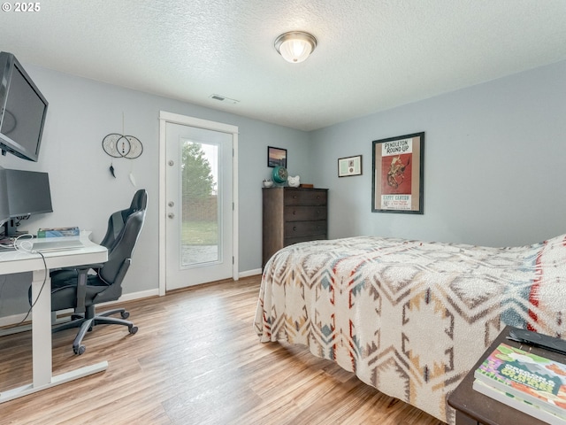 3190 Lily Ln, Mcminnville, OR 97128 - bedroom featuring access to exterior, light wood-style flooring, a textured ceiling, baseboards, and an office area