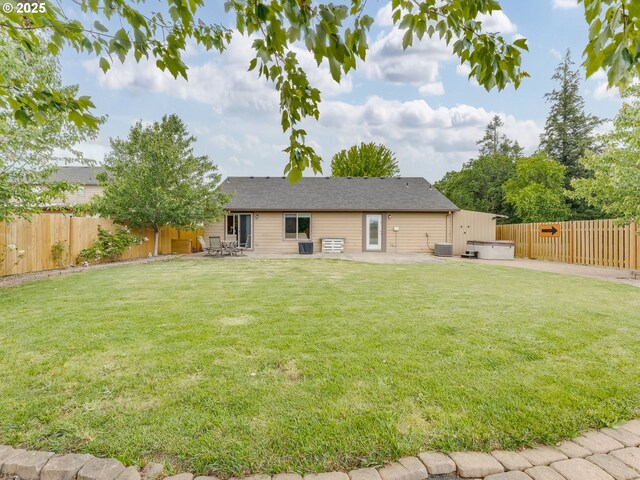 3190 Lily Ln, Mcminnville, OR 97128 - rear view of property featuring a hot tub, a patio area, and central air condition unit