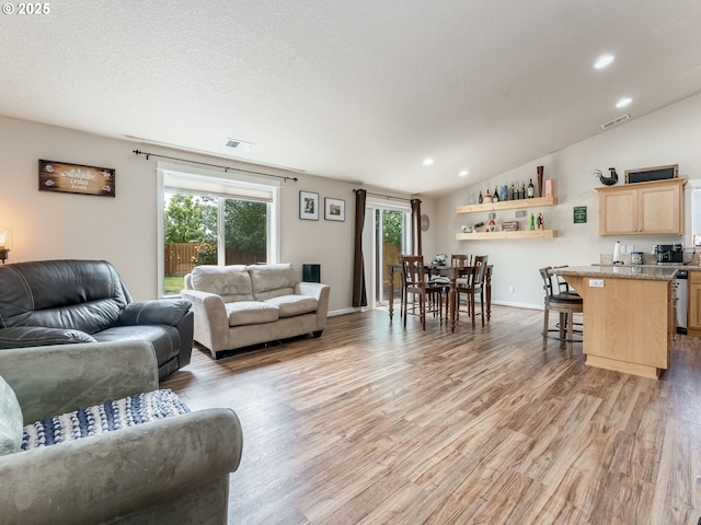 3190 Lily Ln, Mcminnville, OR 97128 - living room with healthy amount of natural light, light wood finished floors, recessed lighting, vaulted ceiling, and baseboards