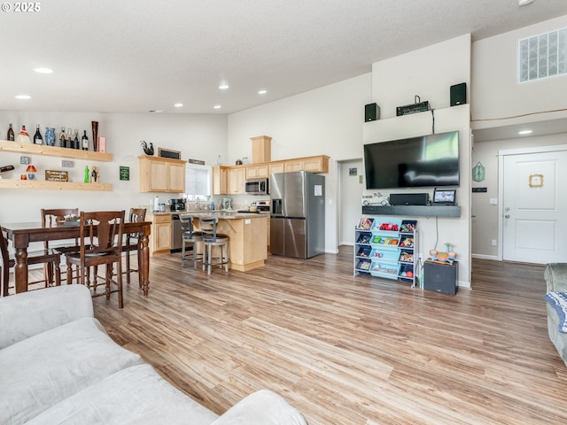 3190 Lily Ln, Mcminnville, OR 97128 - living room with recessed lighting, light wood-type flooring, a high ceiling, and baseboards