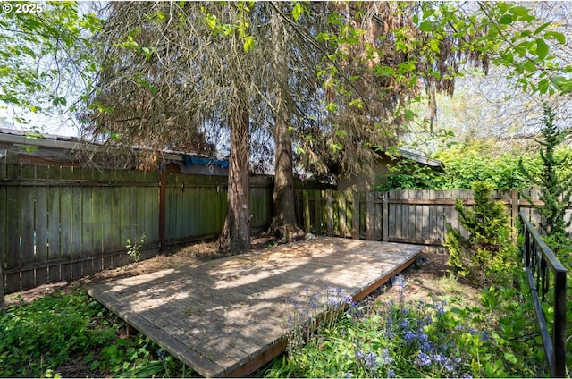 view of yard with a wooden deck and a fenced backyard