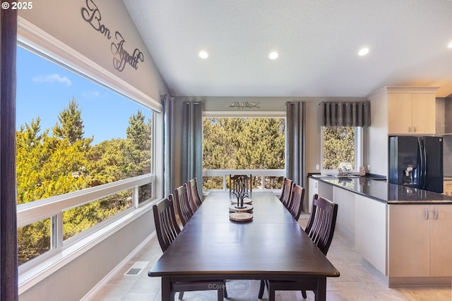 8985 Chinook Ln, Manzanita, OR 97130 - dining space featuring recessed lighting, light tile patterned floors, and vaulted ceiling