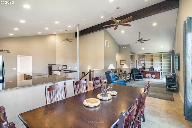 8985 Chinook Ln, Manzanita, OR 97130 - dining space with ceiling fan, a wood stove, beam ceiling, recessed lighting, and high vaulted ceiling