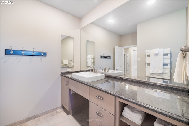 8985 Chinook Ln, Manzanita, OR 97130 - bathroom featuring marble look tile flooring, double vanity, and recessed lighting