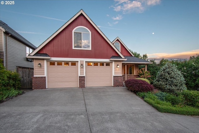 2002 35th St, Washougal, WA 98671 - craftsman-style home featuring brick siding, driveway, a garage, and a porch