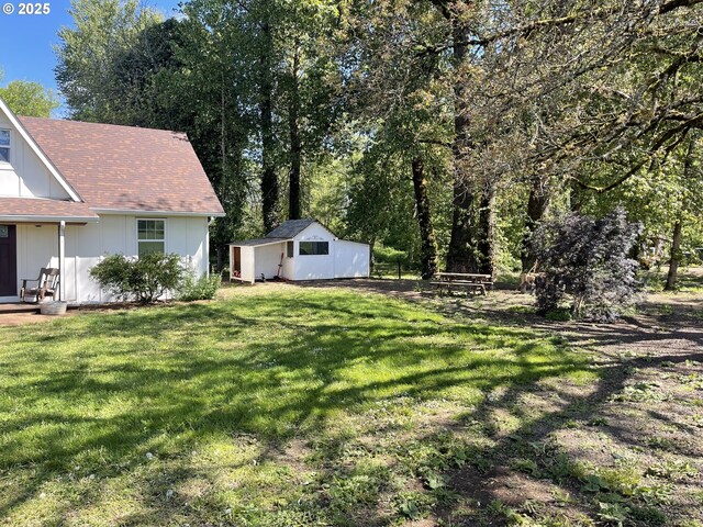 24291 SW Rogers Rd, Sheridan, OR 97378 - view of front of property with a front lawn, covered porch, a storage unit, and board and batten siding