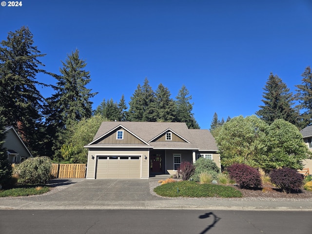 899 NW Angel Heights Rd, Stevenson, WA 98648 - view of front of house featuring a garage, asphalt driveway, and board and batten siding