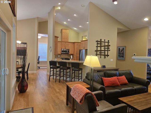 899 NW Angel Heights Rd, Stevenson, WA 98648 - living room featuring light wood-style flooring, recessed lighting, baseboards, and high vaulted ceiling