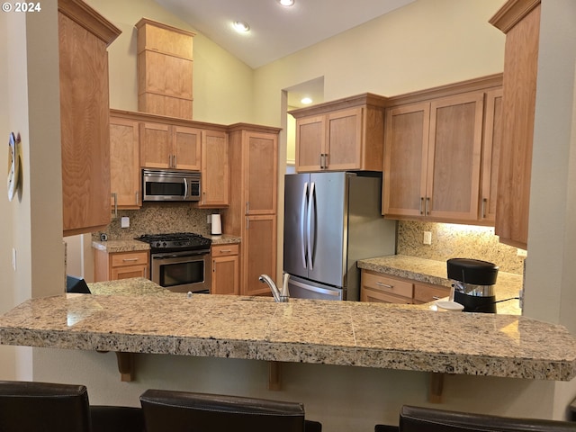 899 NW Angel Heights Rd, Stevenson, WA 98648 - kitchen with appliances with stainless steel finishes, backsplash, light countertops, recessed lighting, and vaulted ceiling