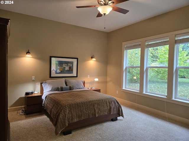 899 NW Angel Heights Rd, Stevenson, WA 98648 - carpeted bedroom with multiple windows, baseboards, and ceiling fan