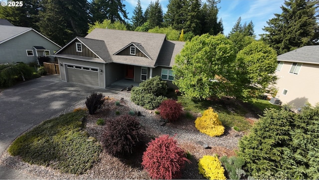 899 NW Angel Heights Rd, Stevenson, WA 98648 - craftsman house featuring board and batten siding, driveway, an attached garage, and central AC unit