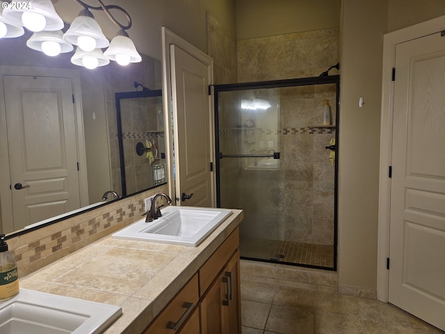 899 NW Angel Heights Rd, Stevenson, WA 98648 - bathroom with double vanity, a stall shower, decorative backsplash, tile patterned floors, and a chandelier