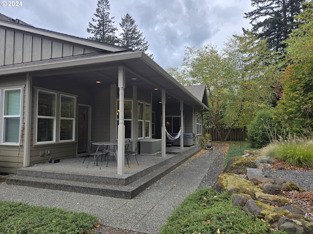 899 NW Angel Heights Rd, Stevenson, WA 98648 - rear view of house with board and batten siding and a patio
