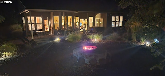 899 NW Angel Heights Rd, Stevenson, WA 98648 - back of house at night with a patio area and an outdoor fire pit