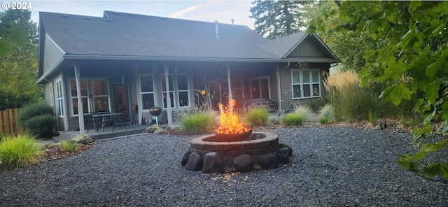 899 NW Angel Heights Rd, Stevenson, WA 98648 - rear view of property with an outdoor fire pit, a patio area, and a shingled roof