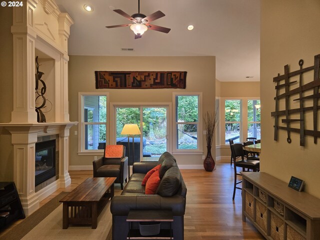 899 NW Angel Heights Rd, Stevenson, WA 98648 - living area featuring ceiling fan, wood finished floors, baseboards, a tile fireplace, and recessed lighting