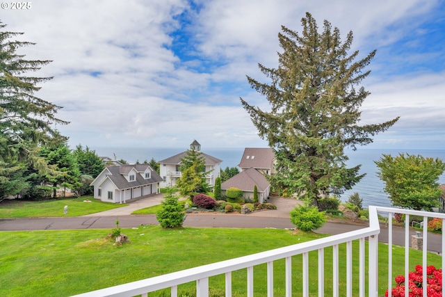90955 Southview Ln, Florence, OR 97439 - view of green lawn featuring a water view and a garage