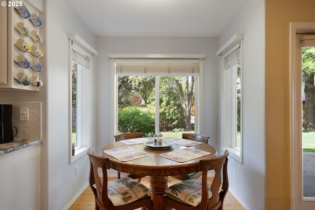 dining room featuring baseboards and light wood-style floors