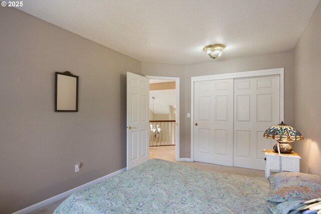 bedroom with light colored carpet, baseboards, and a closet