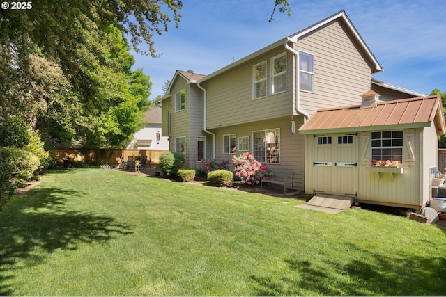 back of house featuring an outdoor structure and a storage shed
