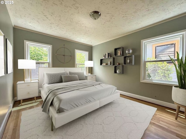 1830 N Winchell St, Portland, OR 97217 - bedroom with ornamental molding, multiple windows, wood finished floors, baseboards, and a textured ceiling