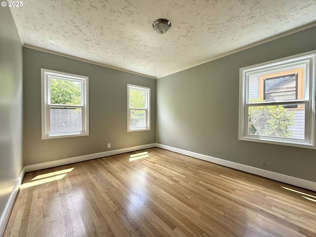 1830 N Winchell St, Portland, OR 97217 - unfurnished room featuring ornamental molding, baseboards, wood finished floors, and a textured ceiling