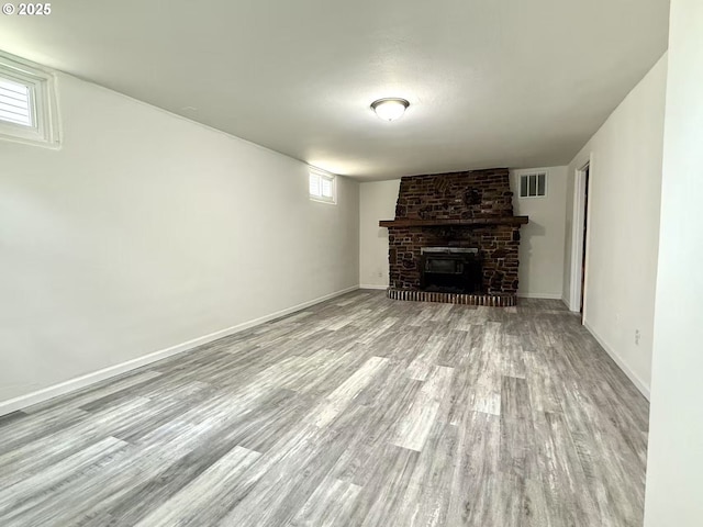 1830 N Winchell St, Portland, OR 97217 - unfurnished living room featuring wood finished floors, a brick fireplace, and baseboards