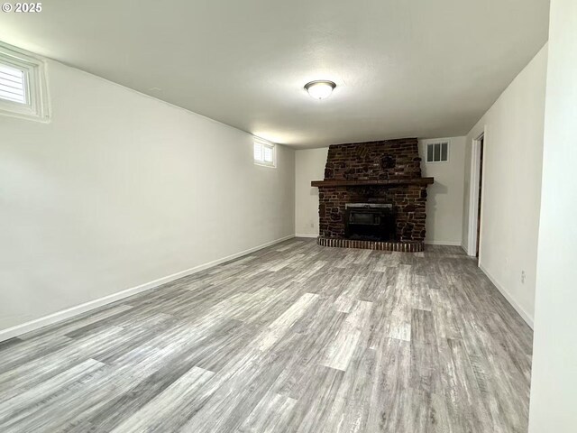 1830 N Winchell St, Portland, OR 97217 - unfurnished living room featuring wood finished floors and a brick fireplace