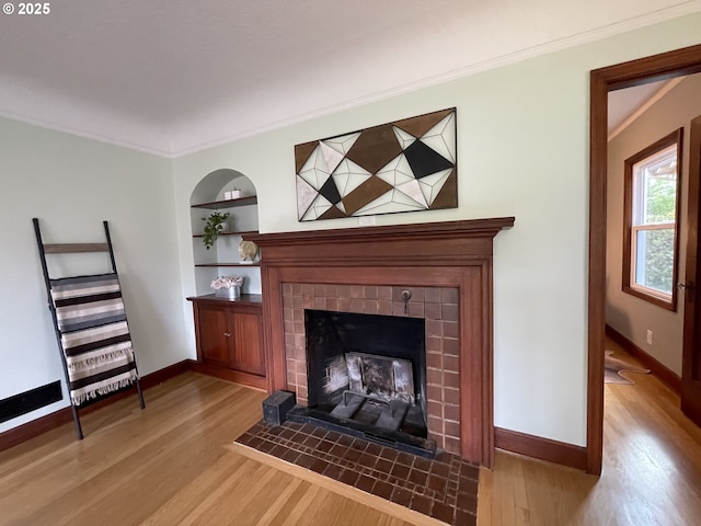 1830 N Winchell St, Portland, OR 97217 - detailed view of wood finished floors, a tiled fireplace, baseboards, and ornamental molding