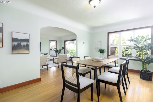 1830 N Winchell St, Portland, OR 97217 - dining room with arched walkways and light wood-style floors