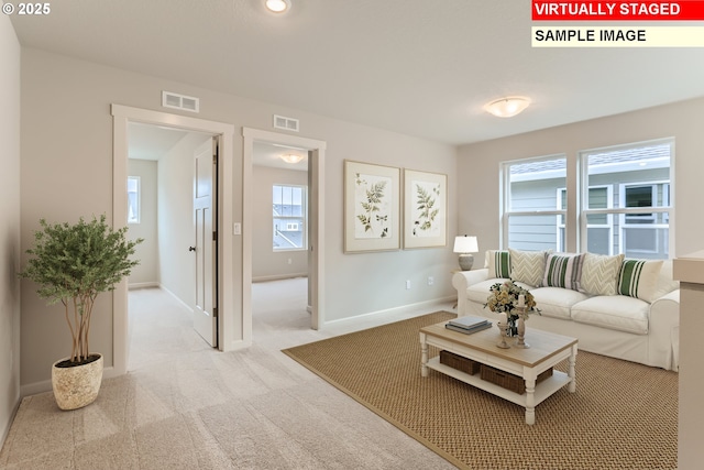 carpeted living room with visible vents and baseboards