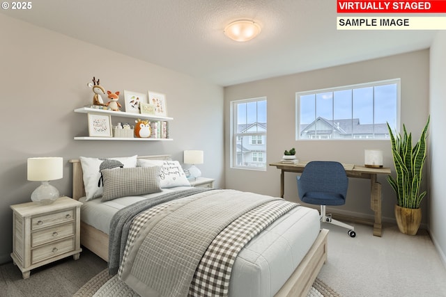 carpeted bedroom featuring built in desk