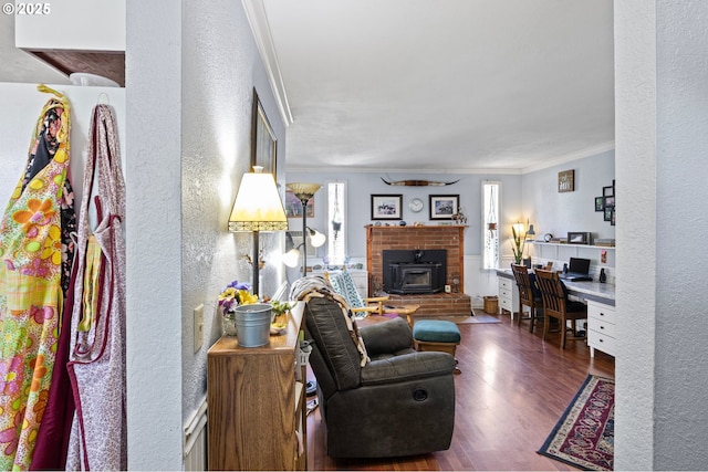 4635 Daisy St, Springfield, OR 97478 - living room featuring crown molding, a textured wall, wood finished floors, a wood stove, and built in study area