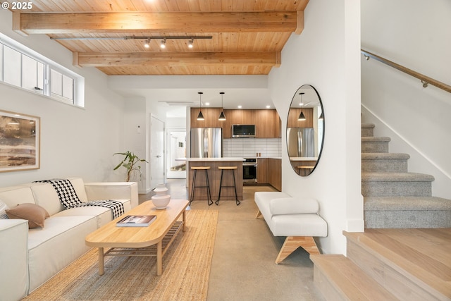 living area with beam ceiling, stairway, light colored carpet, and wood ceiling