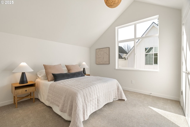 bedroom with baseboards, lofted ceiling, and carpet