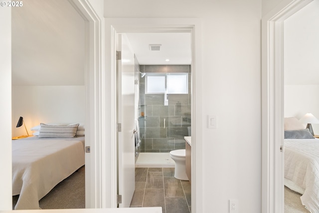 bathroom with connected bathroom, toilet, visible vents, and a shower stall