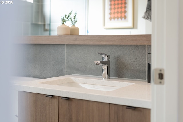 bathroom featuring decorative backsplash and vanity