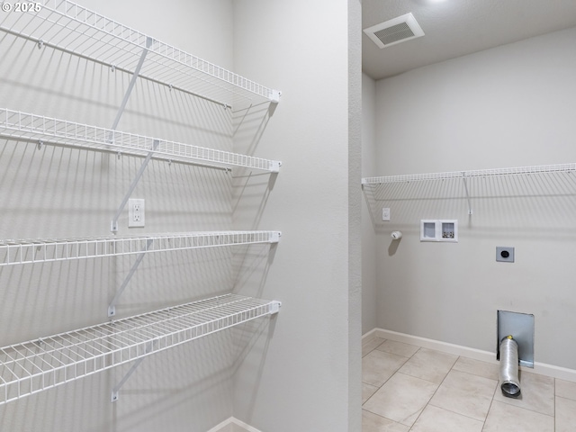 1555 Nolan Ave SE, Albany, OR 97322 - laundry area with washer hookup, electric dryer hookup, hookup for a gas dryer, baseboards, and tile patterned floors
