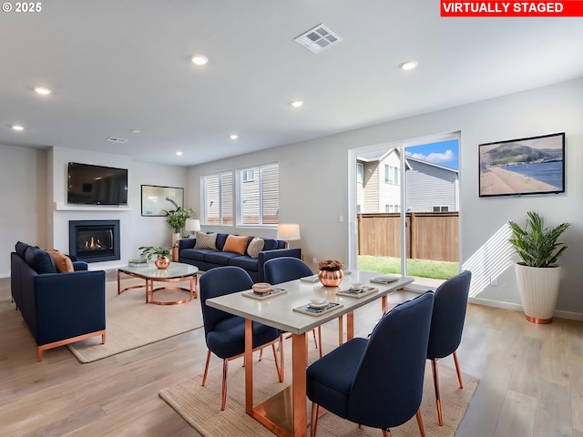 1555 Nolan Ave SE, Albany, OR 97322 - dining area with light wood-style floors, recessed lighting, a glass covered fireplace, and baseboards