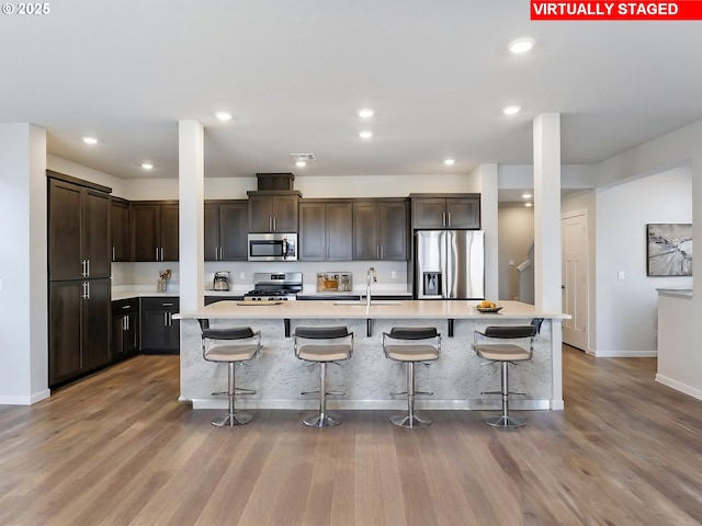 1555 Nolan Ave SE, Albany, OR 97322 - kitchen featuring stainless steel appliances, wood finished floors, light countertops, dark brown cabinets, and recessed lighting