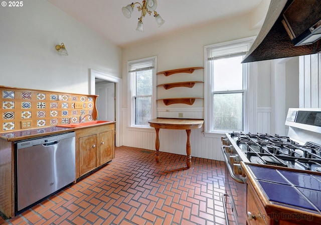 kitchen featuring vaulted ceiling, stainless steel appliances, and custom range hood